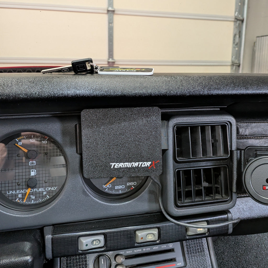 Car dashboard with Terminator logo on a light-colored wall background