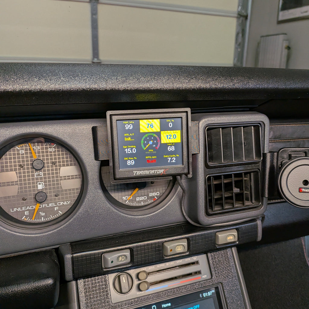 Car dashboard with digital instruments and a touchscreen display.