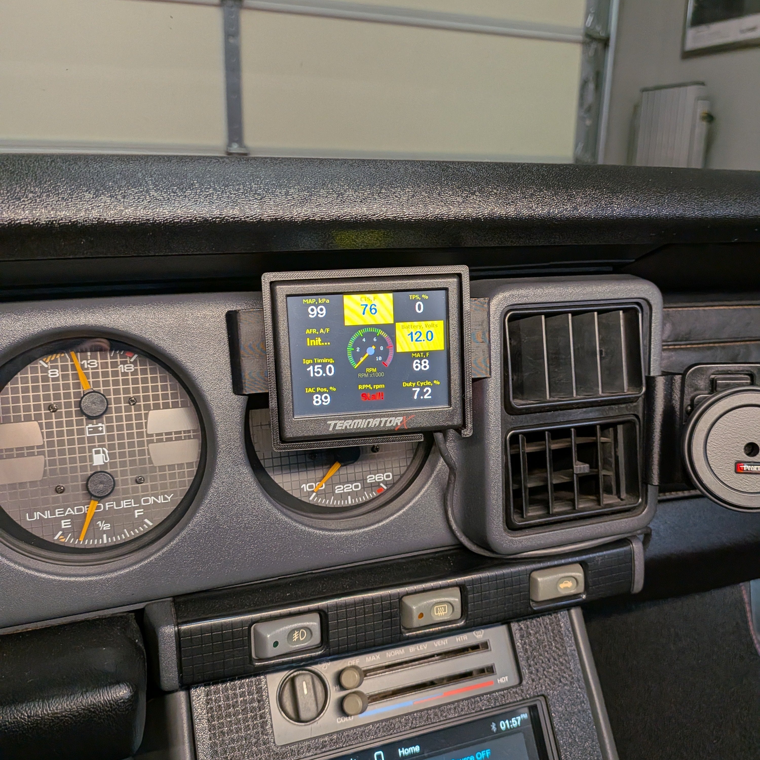 Car dashboard with digital instruments and a touchscreen display.
